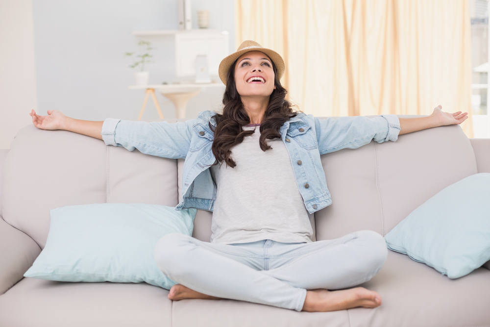 Happy woman in cool home with AC